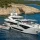 Sunseeker yacht anchored in front of mountain coast